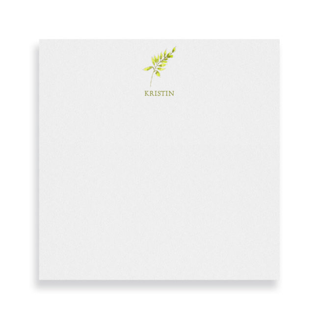fern image adorns a square notepad printed on white paper.