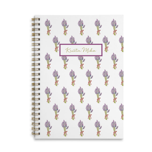 lavender spiral bound notebook with blank pages.